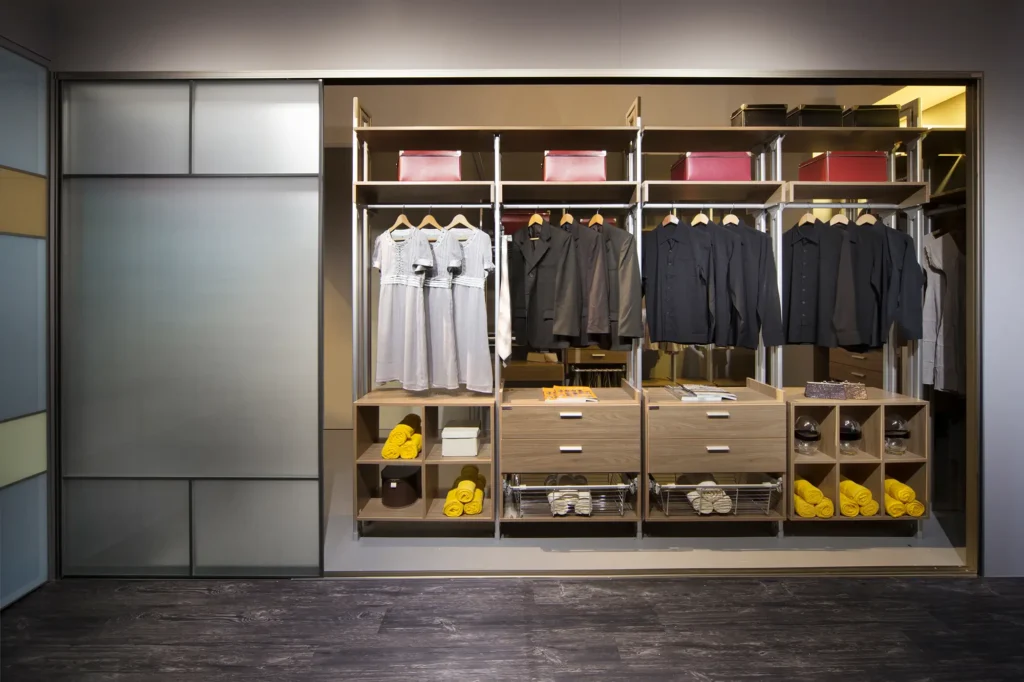 A well-arranged walk-in closet showcasing various clothes and shoes, perfect for learning how to declutter your wardrobe.