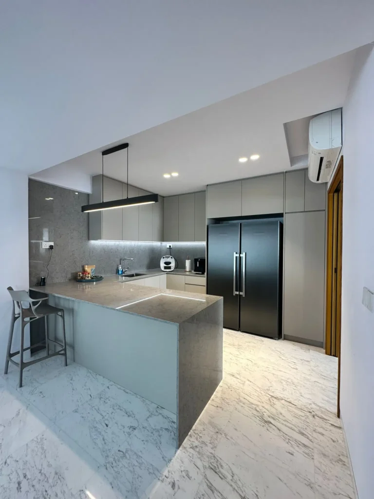 Contemporary kitchen with marble countertops, stainless steel appliances, and a spacious island for dining and preparation.