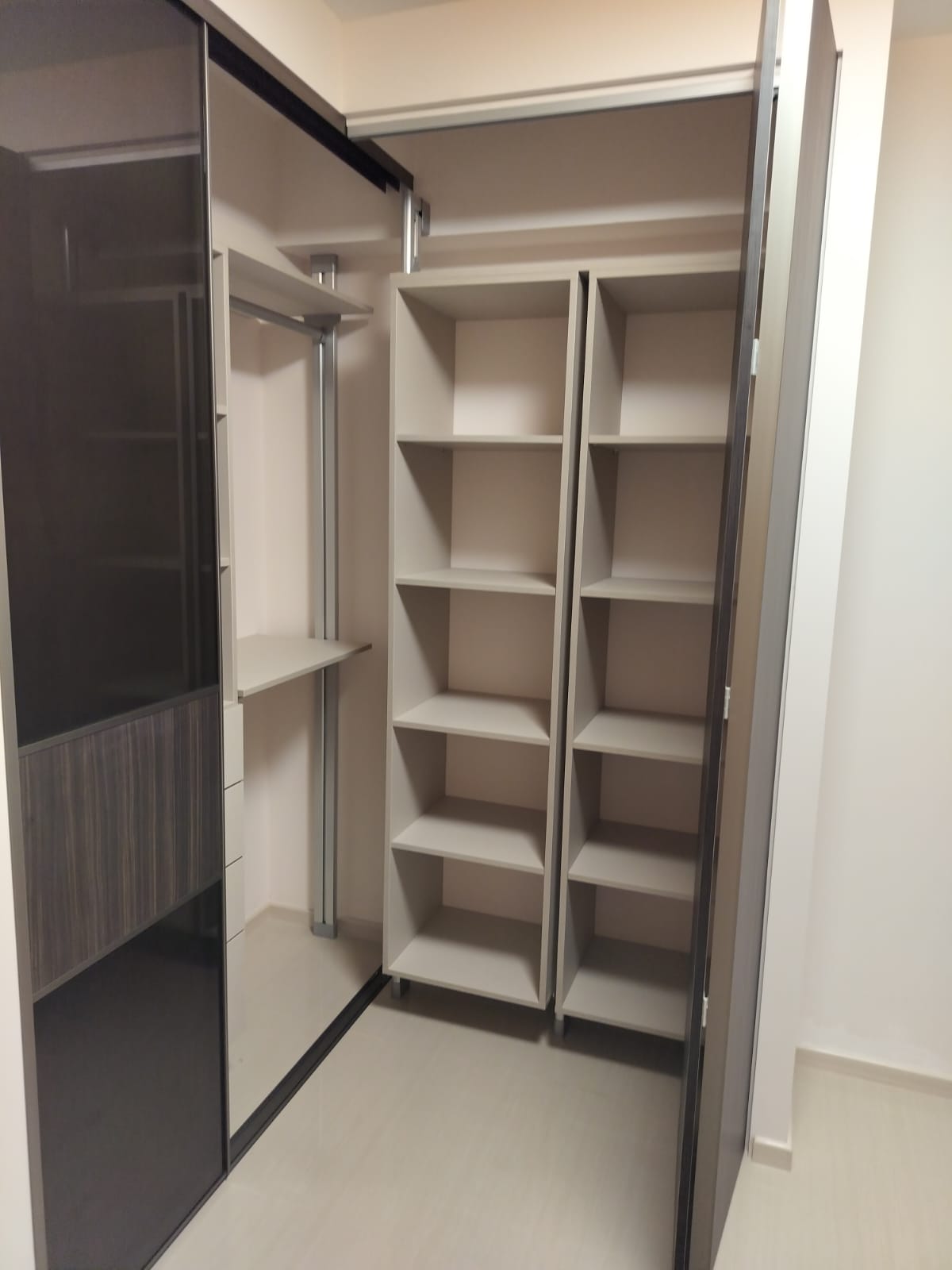 L-shaped HausPole pole system wardrobe turning the corner in a condo bedroom