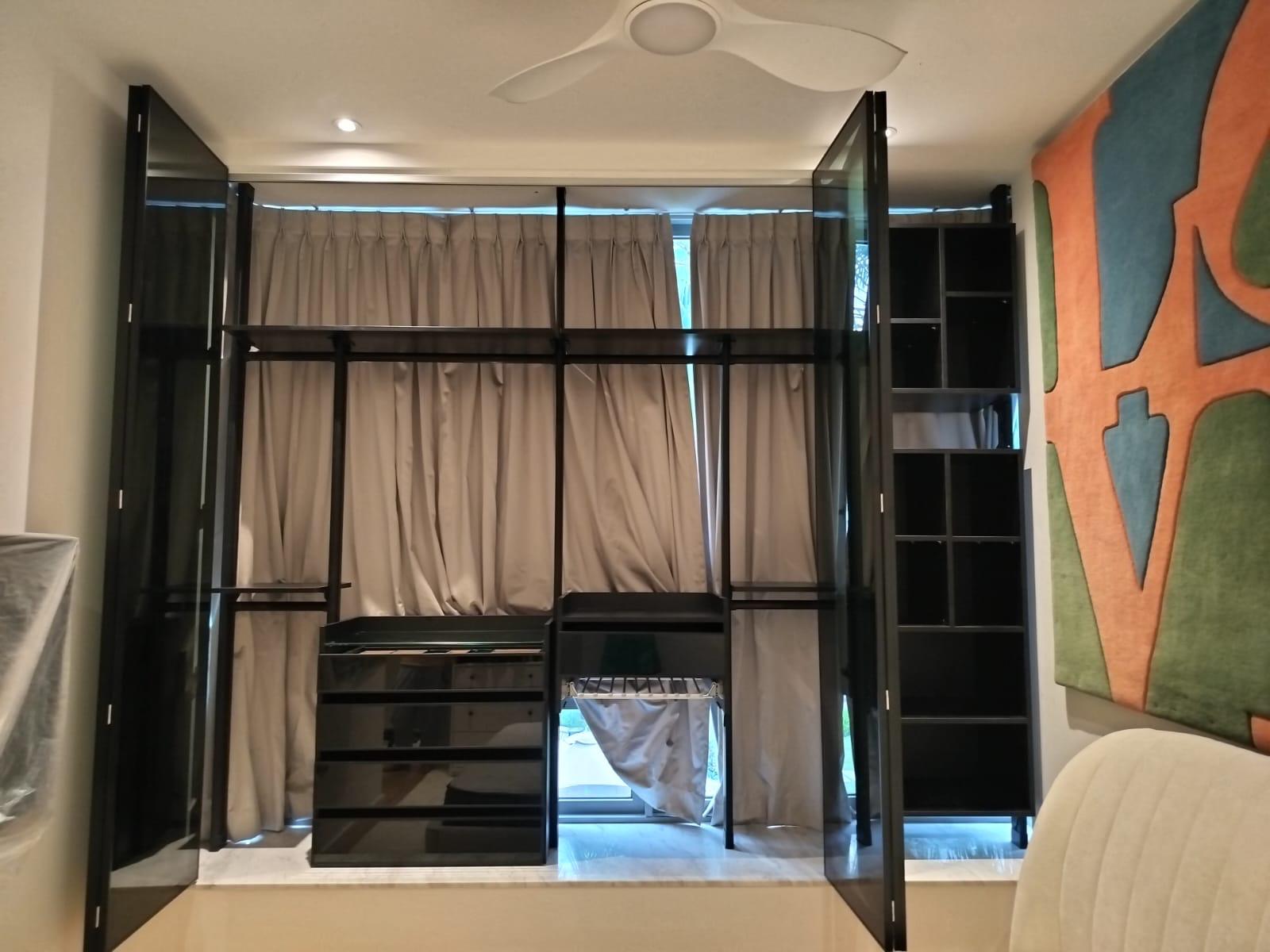 HausPole wardrobe system open above bay window ledge in Tampines condo