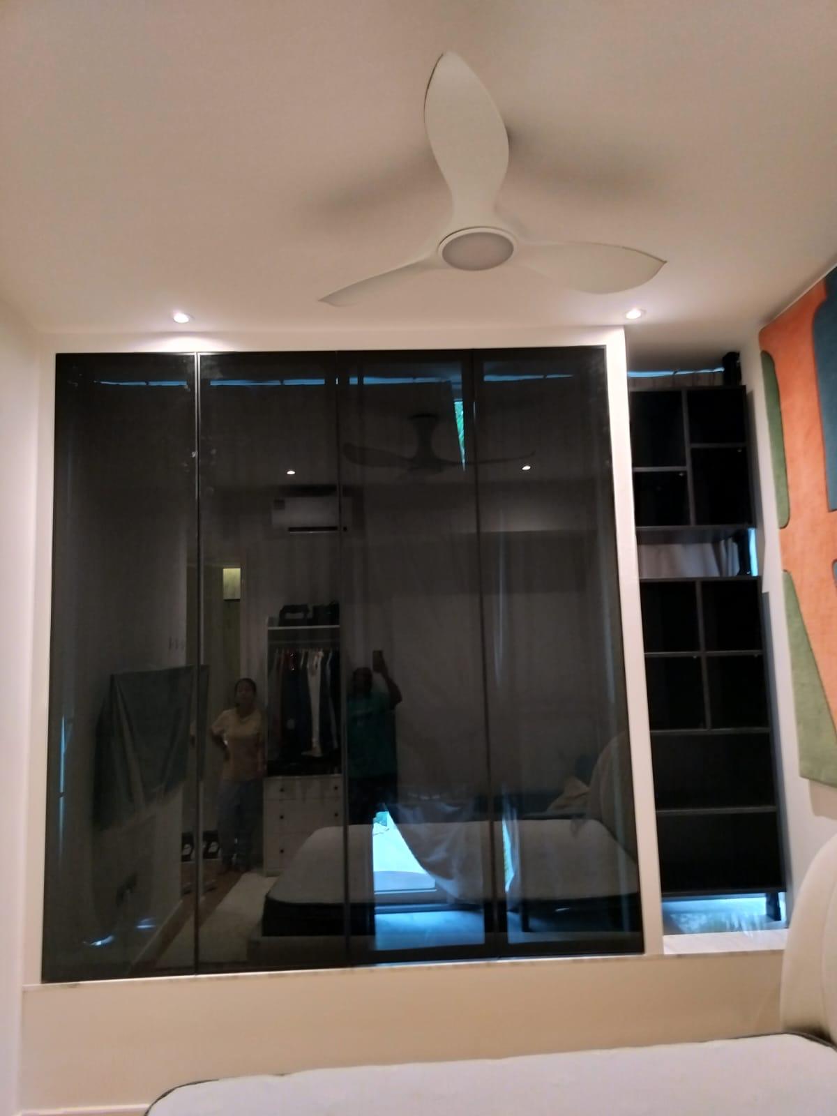 HausPole wardrobe with sliding glass doors closed above bay window in condo