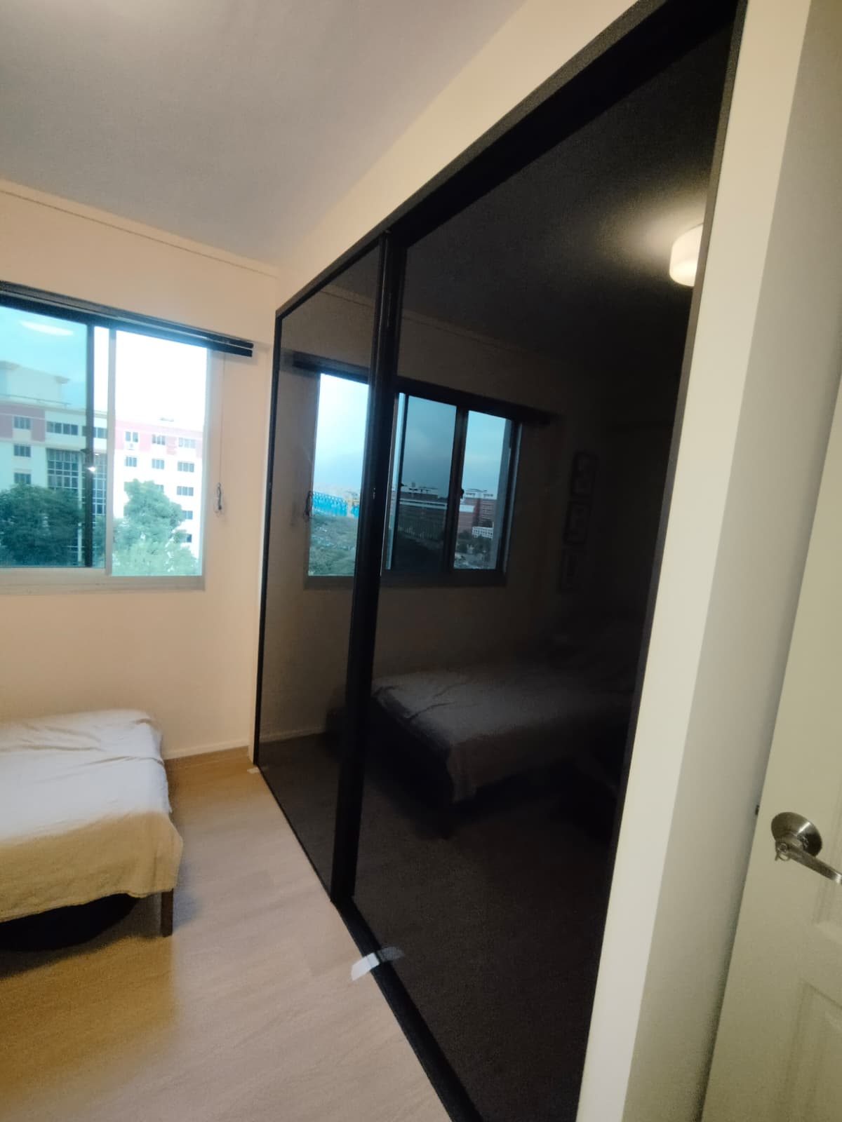 Side B: black opaque glass sliding doors of double-sided wardrobe in Tampines HDB