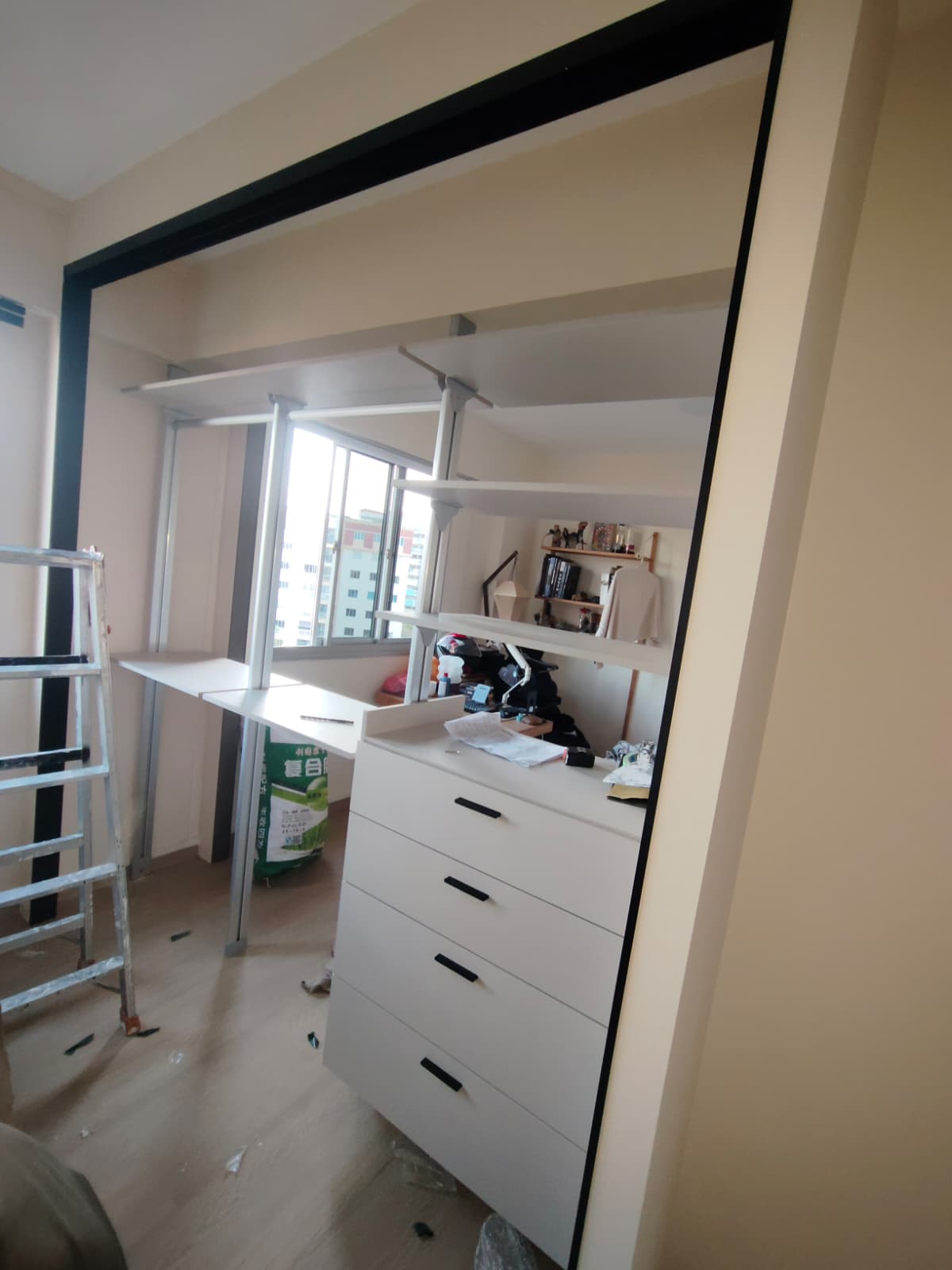 Open interior view of double-sided HausPole wardrobe in Tampines HDB — shelves, rails and drawers