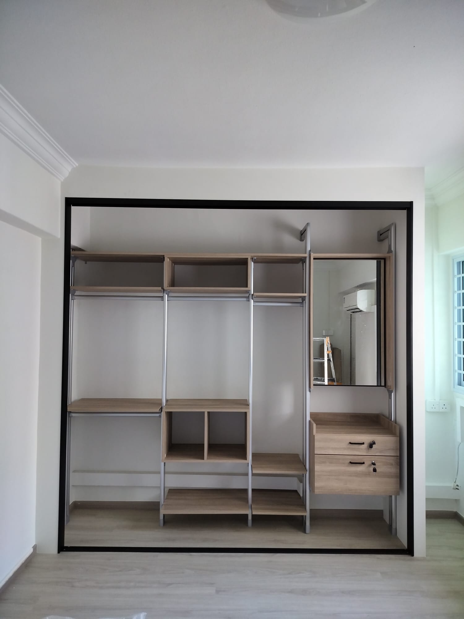 After open: HausPole wardrobe fitting flush across beam and trunking wall in Potong Pasir HDB