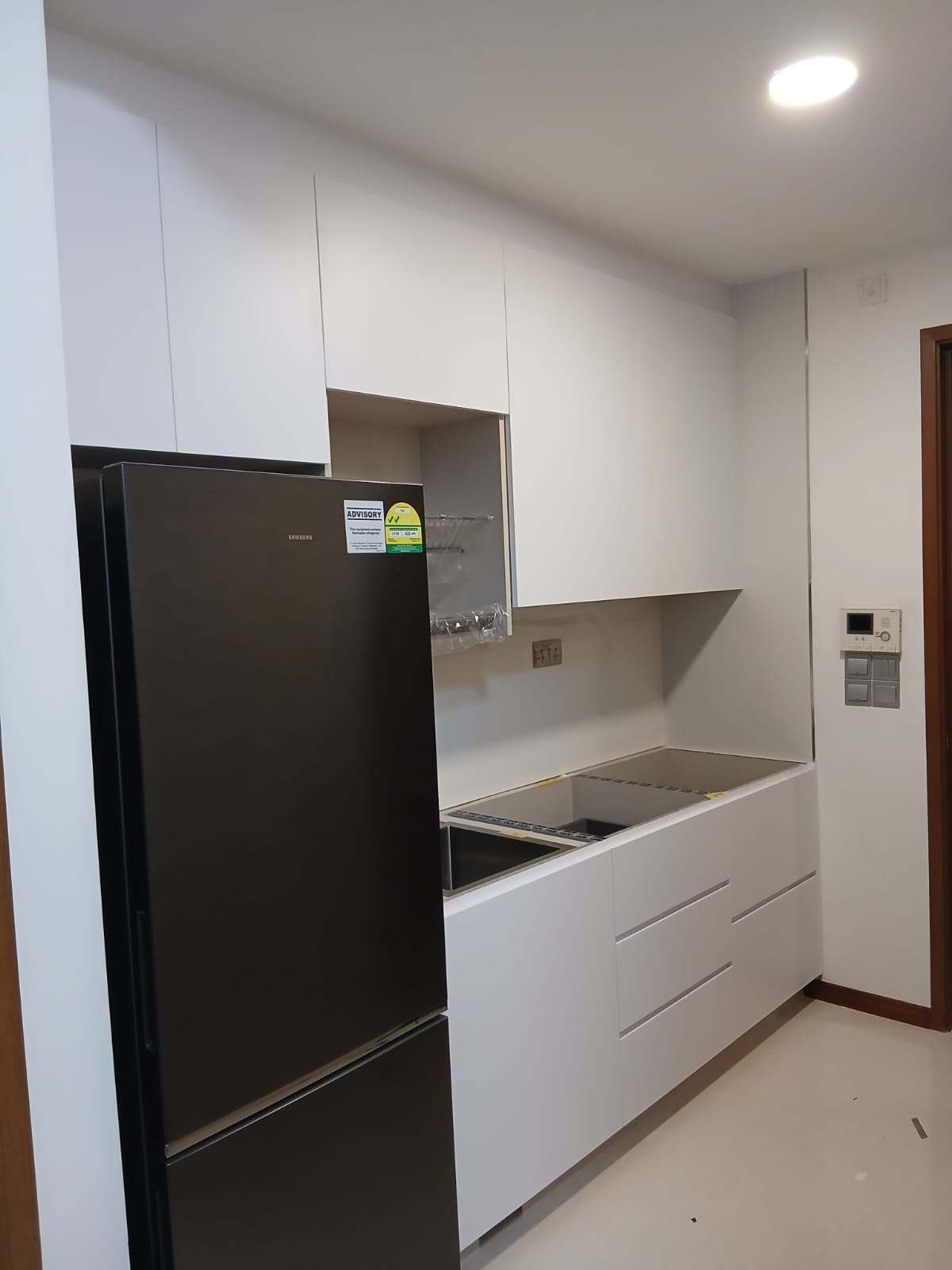Laser-welded aluminium kitchen carcass with WPC laminated doors in a Geylang condo, before countertop installation