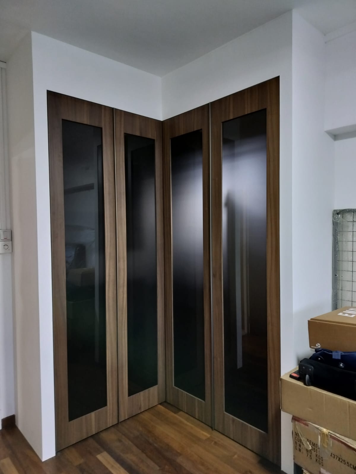 HausPole wardrobe with wooden-framed swing doors and glass inserts